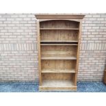 Free standing pine bookcase, measuring approximately 194 cm x 111 cm x 35 cm.