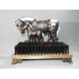 A cast iron and wooden door stop and brush depicting a horse [XDSHB].