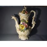 A large Capodimonte Pitcher with applied floral decoration, dragon spout and a cover,
