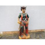 A carved wooden figure depicting a cowboy, measuring approximately 89 cm [H].