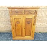 A good quality armoire with carved detailing measuring approximately 147 cm x 110 cm x 45 cm.