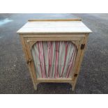 A continental styled pine or light wood larder cupboard with two opening doors and single shelf