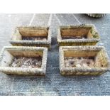 Four rectangular reconstituted stone garden planters.