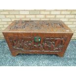 A highly carved camphor wood chest, measuring approximately 59 cm x 104 cm x 54 cm.