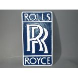 A blue and white wall plaque marked Roll