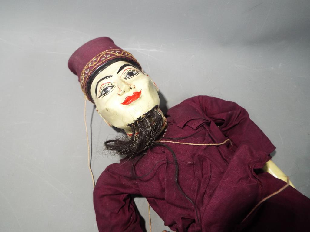 A wooden jointed Malaysian string puppet approximate length 70 cm This lot must be paid for and - Image 2 of 3