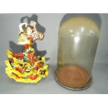 A vintage ceramic model depicting a Flamenco Dancer along with a glass dome and base.
