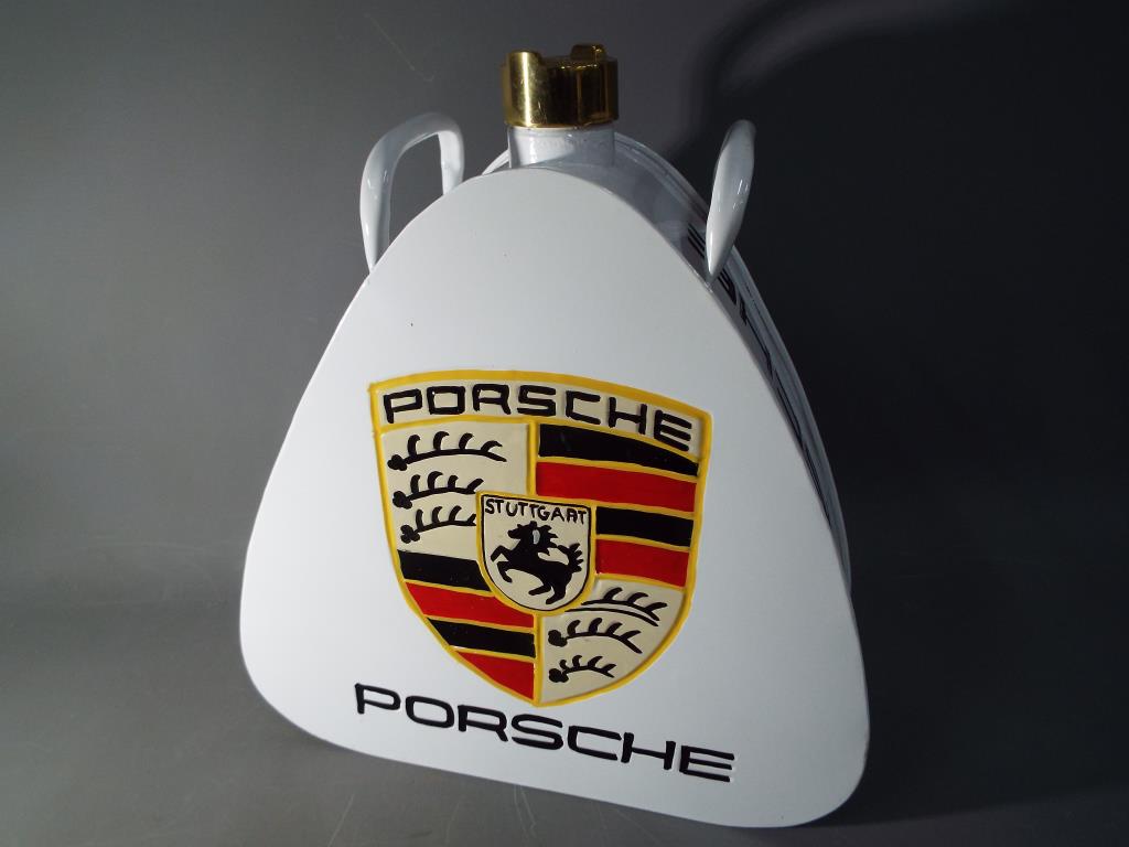 A white petrol can advertising Porsche This lot must be paid for and removed no later than close of