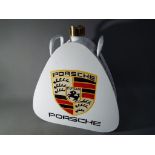 A white petrol can advertising Porsche This lot must be paid for and removed no later than close of