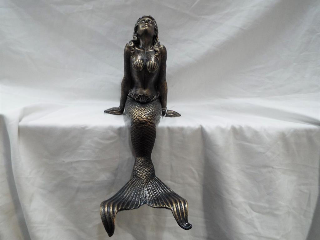 A cast iron model depicting a seated mermaid, approximately 38 cm (h).