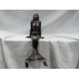 A cast iron model depicting a seated mermaid, approximately 38 cm (h).