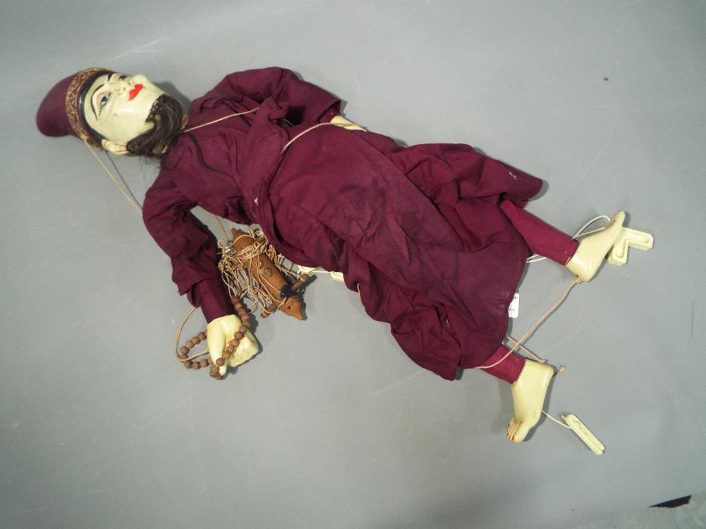 A wooden jointed Malaysian string puppet approximate length 70 cm This lot must be paid for and