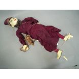 A wooden jointed Malaysian string puppet approximate length 70 cm This lot must be paid for and