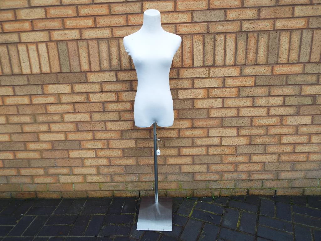 A tailors dummy/mannequin with adjustable chrome stand.