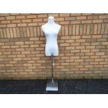 A tailors dummy/mannequin with adjustable chrome stand.