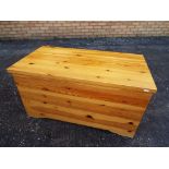 A pine linen chest approximately 49 cm x 92 cm x 51 cm.