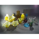 A collection of glassware to include Caithness vase, Mdina seahorse paperweight and similar.