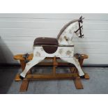 A child's wooden rocking horse on gliders,