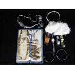 A mixed lot of costume jewellery to include necklaces, cufflinks, wristwatches and similar.