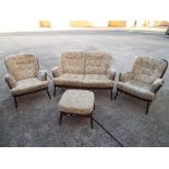 An Ercol lounge suite comprising two seat sofa,