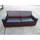 A two seat sofa bed This lot must be paid for and removed no later than close of business on