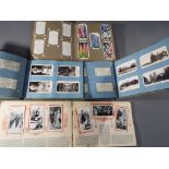 Four cigarette card albums containing complete sets of famous UK landmarks,