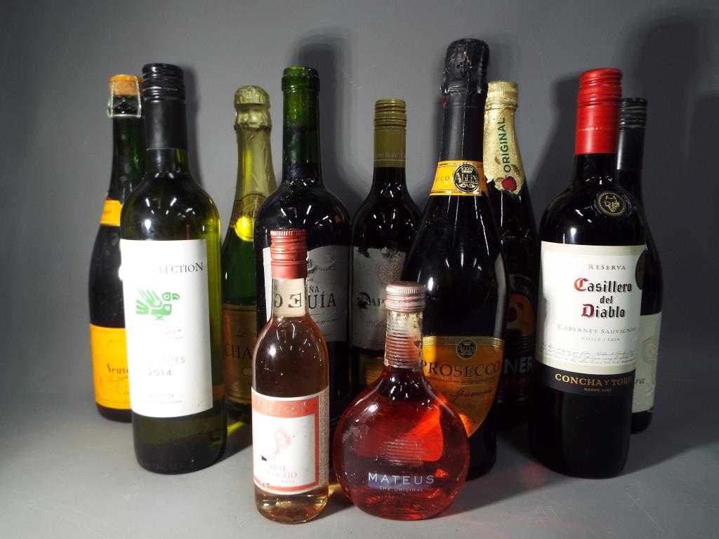 A collection of alcoholic beverages to include Veuve Clicquot, Prosecco, Cabernet Sauvignon,