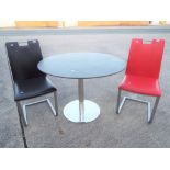 A modern circular topped table and two chairs [3] This lot must be paid for and removed no later