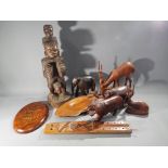 A quantity of carved wooden animals with examples to include lion, rhino,