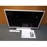 A 32" JVC LED HD TV with built in DVD player, model LT32C676, with remote and instructions.