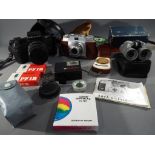 Cameras and Binoculars - a lot to include a quantity of vintage cameras and accessories to include