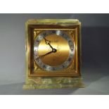 An Elliott onyx cased mantel clock with brass face and silvered chapter ring,