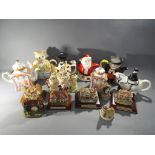 A collection of collectable teapots and models of cottages to include Lilliput Lane and similar.