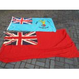 A Royal Air Force association flag and a Merchant Navy Red and signed flag with stitched label with