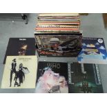 A collection of 33 RPM vinyl records to include ELO, The Who, Fleetwood Mac, Elton John and similar.