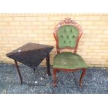 An upholstered chair with decorative carved folding table [2] This lot must be paid for and removed