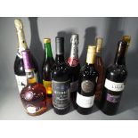 A collection of alcoholic beverages to include Prosecco, Courvoisier, red wine and similar.