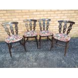 Four carved oak dining chairs.
