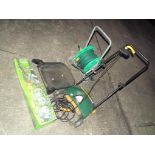 A quantity of gardening tools including lawn raker, hose reel and hedge trimmer.