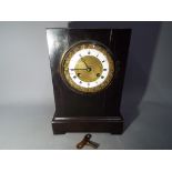 A mantel clock with key.