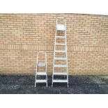 Two sets of metal folding step ladders [2].