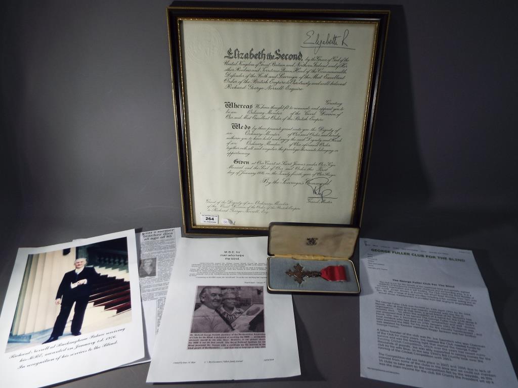 A framed MBE citation and medal awarded to Richard George Norrell in recognition of his service to