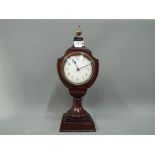 A mahogany cased French mantel clock, Arabic numerals to a white dial with key,