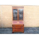 A good quality bureau bookcase with pigeon hole interior, two glazed doors,
