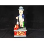 A cast iron money bank in the form of Uncle Sam.
