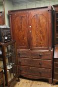 Victorian pine linen press having two doors with four drawers below on bracket feet,