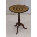 Circular inlaid games table on pedestal tripod base,