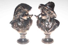 Pair of copper effect metal busts depicting a young boy and girl with a bird on their shoulders,