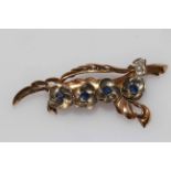 18 carat yellow gold and platinum flower branch brooch set with four sapphires and seven small
