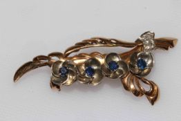 18 carat yellow gold and platinum flower branch brooch set with four sapphires and seven small